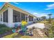 Backyard patio with screened enclosure and landscaping at 9470 Sw 66Th Loop, Ocala, FL 34481