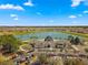 Aerial view showing clubhouse, lake, and golf course at 9470 Sw 66Th Loop, Ocala, FL 34481