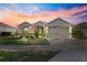 One-story house with landscaped yard, two-car garage, and American flag at 9470 Sw 66Th Loop, Ocala, FL 34481