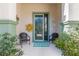 Front porch with seating area and green door at 9470 Sw 66Th Loop, Ocala, FL 34481