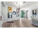 Living room with green door, decorative wall art, and hardwood floors at 9470 Sw 66Th Loop, Ocala, FL 34481