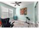 Home office with light teal walls, and a large window with shutters at 9470 Sw 66Th Loop, Ocala, FL 34481