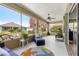 Relaxing screened porch with seating and ceiling fan at 9470 Sw 66Th Loop, Ocala, FL 34481