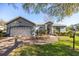 Charming one-story home showcasing a red front door and brick walkway at 9554 Sw 93Rd Loop, Ocala, FL 34481