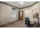 Bright home office features built-in shelving and carpet flooring at 9554 Sw 93Rd Loop, Ocala, FL 34481