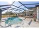 Screened pool and patio with lounge chairs at 9554 Sw 93Rd Loop, Ocala, FL 34481