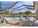 Relaxing screened pool area with patio furniture, ready for entertaining at 9554 Sw 93Rd Loop, Ocala, FL 34481