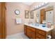 Bathroom with wood vanity and large mirror at 9802 Sw 88Th Ter # A, Ocala, FL 34481