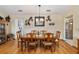 Bright dining room featuring a wood table and chairs, hardwood floors, and decorative wall shelves at 9802 Sw 88Th Ter # A, Ocala, FL 34481