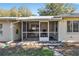 Home exterior showcasing a screened porch and backyard at 9802 Sw 88Th Ter # A, Ocala, FL 34481