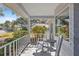 White rocking chairs and small table on a covered porch with neighborhood view at 9802 Sw 88Th Ter # A, Ocala, FL 34481