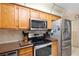 Kitchen features stainless steel appliances and oak cabinets at 9802 Sw 88Th Ter # A, Ocala, FL 34481