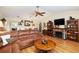 Living room with sectional sofa, fireplace, and built-in shelving at 9802 Sw 88Th Ter # A, Ocala, FL 34481