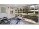 Screened porch offers outdoor space with seating area at 9802 Sw 88Th Ter # A, Ocala, FL 34481