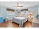 Bright bedroom with wood floors and ceiling fan at 9836 Se 175Th Pl, Summerfield, FL 34491