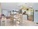 Dining area with light wood table and chairs, open to the kitchen and living room at 9836 Se 175Th Pl, Summerfield, FL 34491