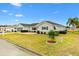 Ranch-style house with grey siding, screened porch, and neatly landscaped yard at 9836 Se 175Th Pl, Summerfield, FL 34491