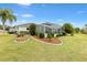 Rear view of house showcasing pool and landscaping at 9836 Se 175Th Pl, Summerfield, FL 34491