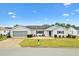 Front view of single-story house with driveway and landscaping at 9836 Se 175Th Pl, Summerfield, FL 34491