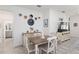 Charming dining area featuring a wooden table and white chairs at 9945 Sw 100Th Terrace Rd, Ocala, FL 34481