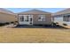 Landscaped backyard view of house and sunroom at 9945 Sw 100Th Terrace Rd, Ocala, FL 34481