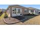 Backyard view of house showing sunroom and landscaping at 9945 Sw 100Th Terrace Rd, Ocala, FL 34481