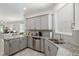 Spacious kitchen featuring granite countertops and gray cabinets at 9945 Sw 100Th Terrace Rd, Ocala, FL 34481