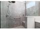 Large walk-in shower with built-in seat and grey tile at 9945 Sw 100Th Terrace Rd, Ocala, FL 34481