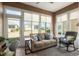 Relaxing sunroom featuring a couch and rocking chair at 9945 Sw 100Th Terrace Rd, Ocala, FL 34481