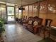 Relaxing sunroom featuring a leather couch and rocking chair at 10800 Sw 62Nd Ave, Ocala, FL 34476