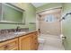 Bathroom with wood cabinets, granite countertop and bathtub at 10882 Sw 62Nd Ave, Ocala, FL 34476