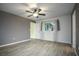 Spacious bedroom with ceiling fan and wood-look tile flooring at 10882 Sw 62Nd Ave, Ocala, FL 34476