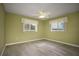 Light and airy bedroom with ceiling fan and wood-look tile flooring at 10882 Sw 62Nd Ave, Ocala, FL 34476