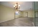 Spacious dining area with a chandelier and mirror at 10882 Sw 62Nd Ave, Ocala, FL 34476