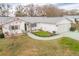 Single-story house with a gray roof, white exterior, and a landscaped front yard at 10882 Sw 62Nd Ave, Ocala, FL 34476