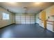 Spacious garage with painted floor, cabinets, and laundry hookups at 10882 Sw 62Nd Ave, Ocala, FL 34476