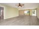 Living room with tile floors, ceiling fan and view of the front yard at 10882 Sw 62Nd Ave, Ocala, FL 34476