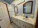 Double vanity bathroom with large mirrors at 10895 Sw 90Th Ter, Ocala, FL 34481