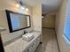 Bathroom with granite countertop, white sink, and subway tile at 10895 Sw 90Th Ter, Ocala, FL 34481