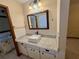 Bathroom with granite countertop, white sink, and subway tile at 10895 Sw 90Th Ter, Ocala, FL 34481