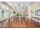 Light-filled dance studio with hardwood floors and floor to ceiling mirrors at 10895 Sw 90Th Ter, Ocala, FL 34481