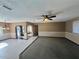 Open concept living room with carpet and tile flooring at 10895 Sw 90Th Ter, Ocala, FL 34481