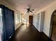 Bright living room featuring dark laminate floors and built-in shelving at 10895 Sw 90Th Ter, Ocala, FL 34481