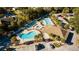 Aerial view of a community clubhouse with a pool, splash pad, and parking at 10895 Sw 90Th Ter, Ocala, FL 34481