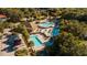 Overhead shot of a community pool featuring palm trees, lounge chairs, and multiple pools at 10895 Sw 90Th Ter, Ocala, FL 34481