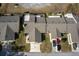 Aerial view of houses with gray roofs and driveways at 10918 Se 50 Ave, Belleview, FL 34420