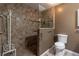 Bathroom with walk-in shower, grab bars, and toilet at 10918 Se 50 Ave, Belleview, FL 34420