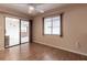 Bedroom features wood floors, a window with blinds, and a ceiling fan at 10918 Se 50 Ave, Belleview, FL 34420