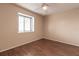 Bright bedroom with wood floors, window, and ceiling fan at 10918 Se 50 Ave, Belleview, FL 34420