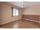 Spacious bedroom with wood floors, brick accent wall, and ceiling fan at 10918 Se 50 Ave, Belleview, FL 34420